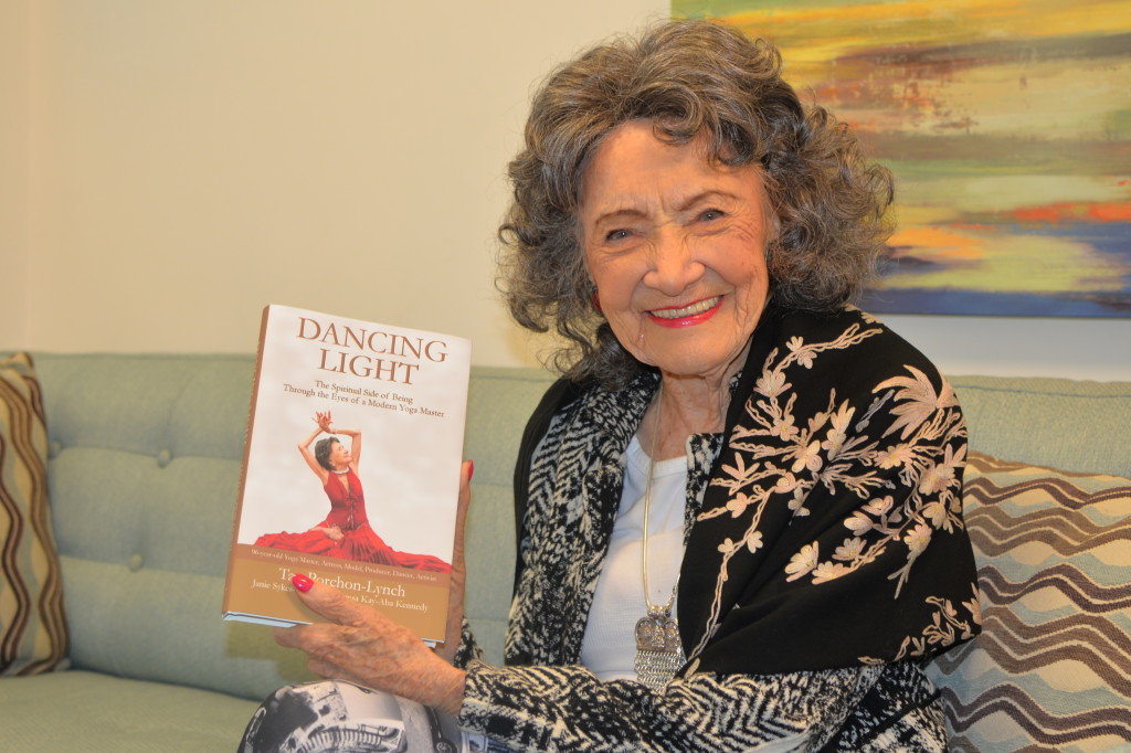96-year-old yoga master Tao Porchon-Lynch holding her new book, Dancing Light, at the Steve Harvey Show green room in Chicago