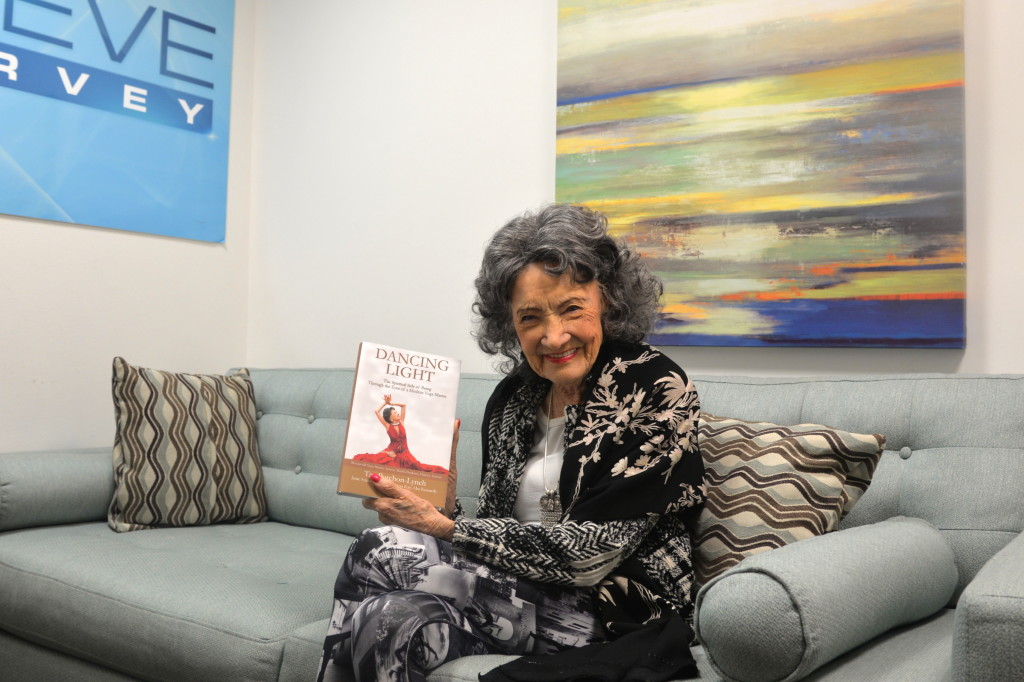 96-year-old Tao Porchon-Lynch holding her new book, Dancing Light, at the Steve Harvey Show green room in Chicago